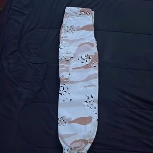 Camo themed cargo pants with button pockets on the legs and two pockets up top
